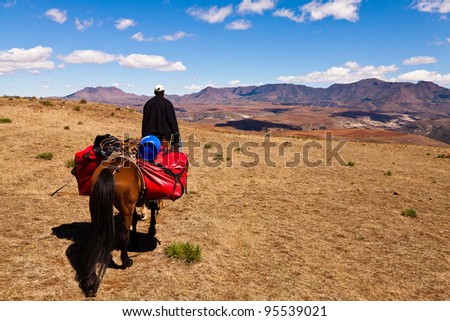 Man riding on a horse in the mountains of africa