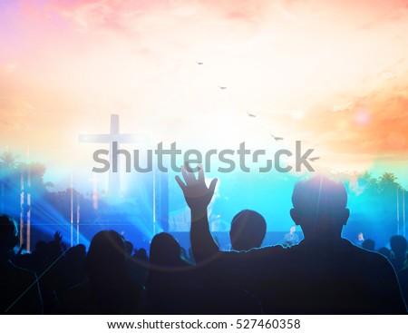 Human rights concept: Silhouette many people raised hands over sunset background.