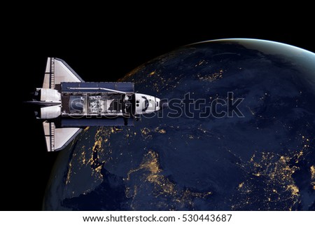 Space Shuttle and aerial night view of the World. Elements of this image furnished by NASA.