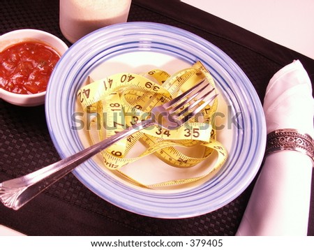 tape measure in a bowl like pasta with sauce, cheese and a napkin. fork in bowl suggest eating healthy.