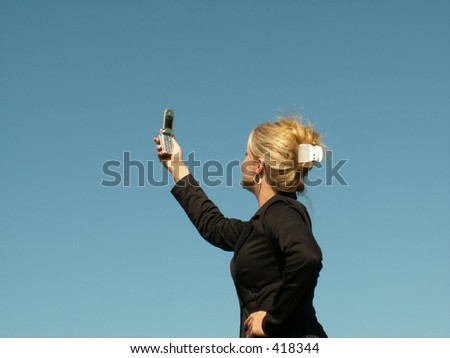 business woman searching for signal on her cell phone