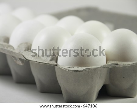 carton of a dozen eggs with focus on front corner of carton