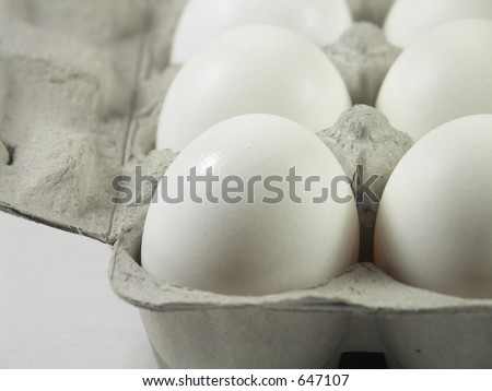 carton of a dozen eggs with focus on front left corner of carton
