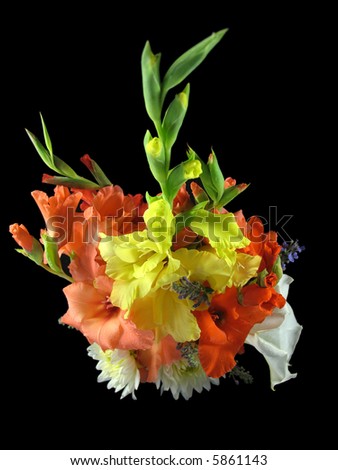 Vase of gladiolas, dahlia\'s and other assorted flowers on a black with a bird\'s eye view.