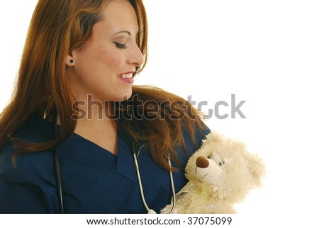 Attractive Caucasian nurse holding stuffed animal.