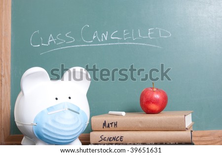 Ceramic pig with surgical mask sits with books and an apple in front of a chalkboard
