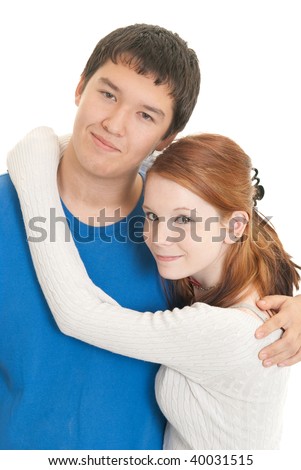 stock photo A cute Caucasian teenage girl hugs her Asian teen boyfriend