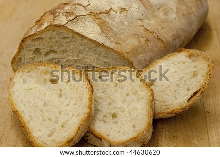 Fresh sliced Italian bread on a cutting board.