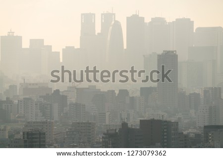 Air pollution dust smoke in the urban city. Low visibility city view with haze and fog.