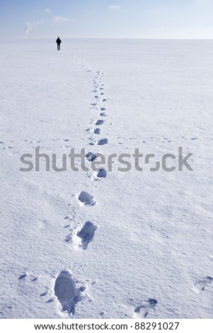 Man walking i snow making foot prints