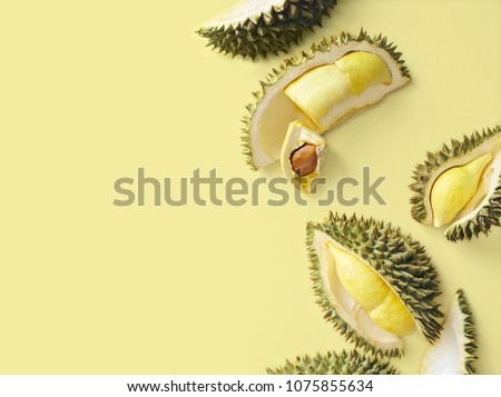 Fresh cut durian on a pastel yellow background, king of fruit from Thailand, creative food concept