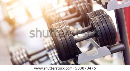dumbbells in gym. Close up many dumbells in sport fitness centre.
