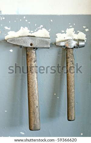 two hammers hanging on wall