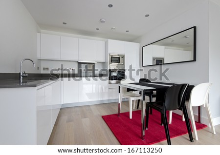 Contemporary Fully Fitted Kitchen With White Units, Modern Chrome Finish Appliances, Modern Dining Table And Designer Chairs