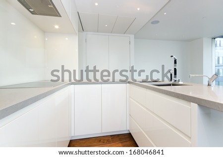 Contemporary modern fully fitted kitchen in white with top spec appliances and granite worktops