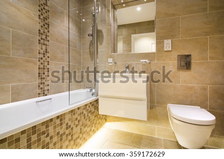 Luxury three piece bathroom in beige - brown with mosaic and natural stone tiles