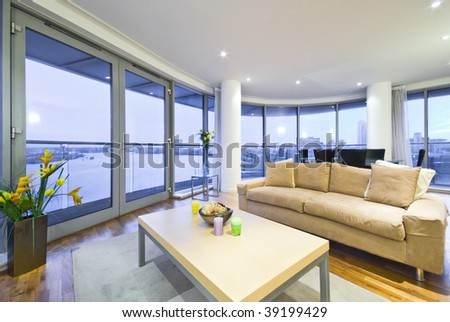 new living room with designer sofa and floor to ceiling windows