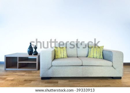 large contemporary designer sofa with side table and reading decorations