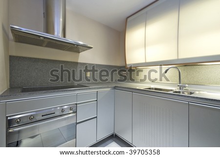 modern designer kitchen with silver cupboards and granite worktop