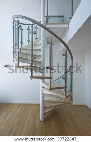 solid newel stairs with wooden steps and glass and steel rail