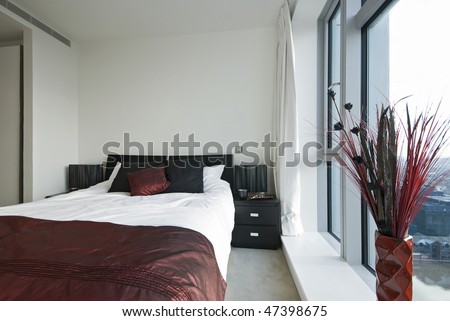 Modern double bedroom with built in wardrobe and floor to ceiling windows