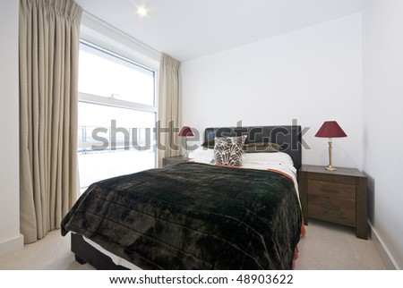 Modern double bedroom with king size bed and wooden bedside tables