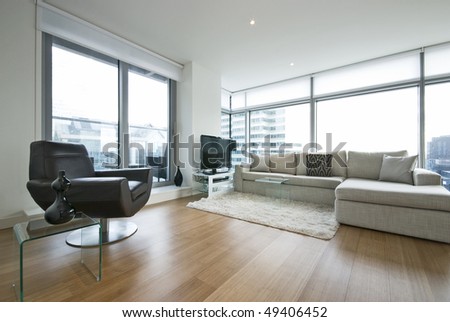 Contemporary living room with designer furniture, floor to ceiling windows and panoramatic views