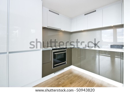 Modern fully fitted kitchen with kitchen appliances in army green and white