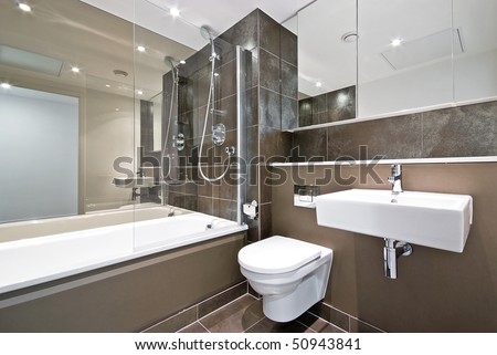 Modern Family Bathroom With Large Bath Tub And Natural Stone Tiled ...