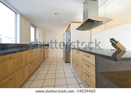 Brand new contemporary open plan kitchen with modern appliances and double amirican style fridge