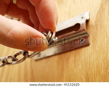 Security chain held by a hand illustrating safety device