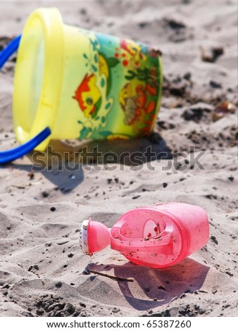 Toys left at the beach, bucket and water-can