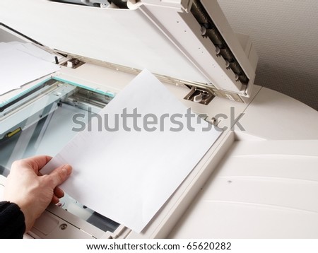 A person handling a multi purpose copier machine