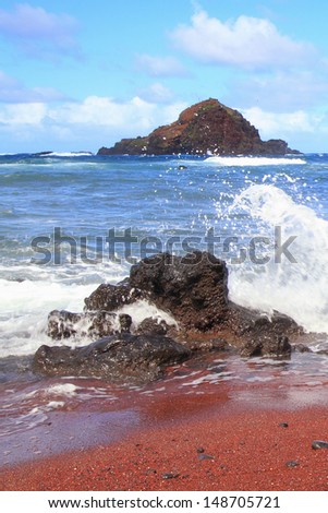 Rare red sand beach and crashing surf on the island of Maui, Hawaii