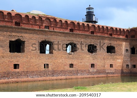 The massive but unfinished Fort Jefferson, on Florida\'s Garden Key, features a moat and a lighthouse.