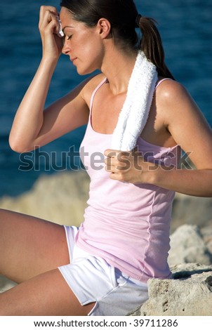 Woman wiping her face after working out