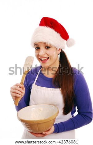 Happy christmas chef about to lick cake mixture on white background