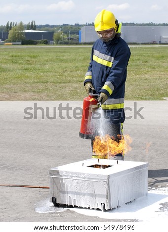 Firefighter using fire extinguisher