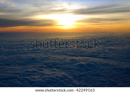 Sunrise over clouds at 30,000 feet in the air