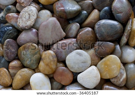 round polished rocks usually rounded and washed in rivers and seas