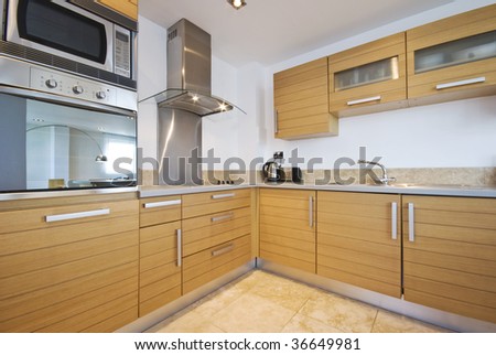 fully fitted modern kitchen in birch wood finish with modern appliances