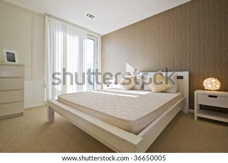 modern designe double bedroom in white with brown wave patterned wall paper