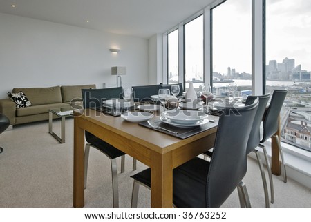 living room with dining table set up and floor to ceiling windows
