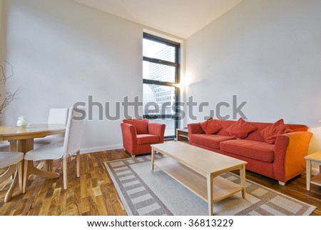 high ceiling modern living room with orange sofa and coffee table