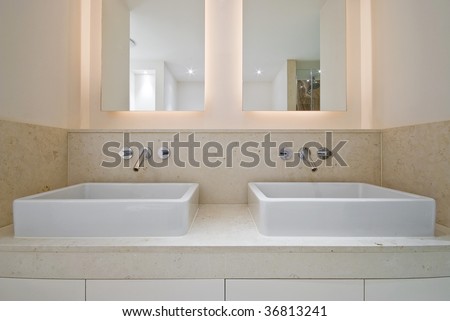 double ceramic bathroom sink and double mirror with natural stone tiles