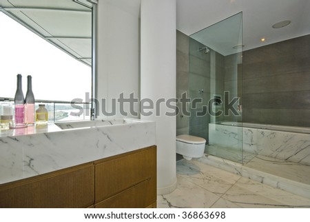 marble bathroom with floor to ceiling window, tv and sound system