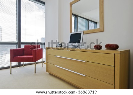 chest of drawers in birch with red armchair and mirror
