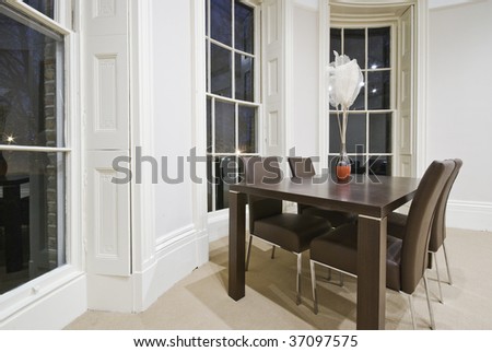 dining area with four seats in oval bay window
