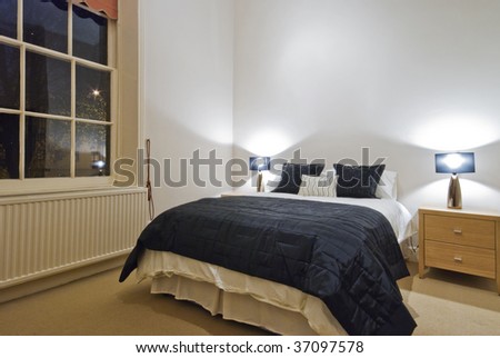 classic bedroom with contemporary furniture at night