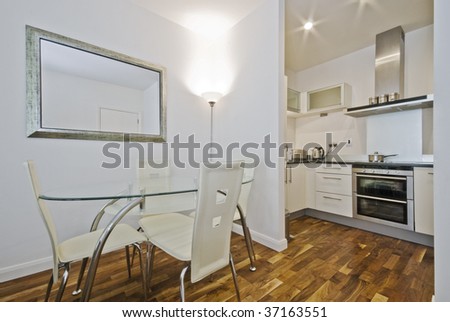 open plan kitchen with dining table and designer chairs